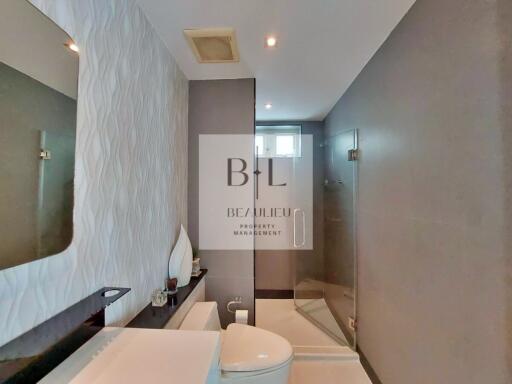 Modern bathroom with a single sink and glass shower enclosure