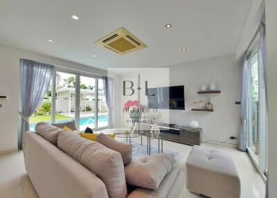 Spacious modern living room with poolside view