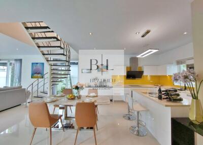 Modern kitchen and dining area with staircase