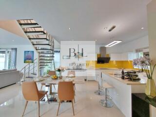 Modern kitchen and dining area with staircase