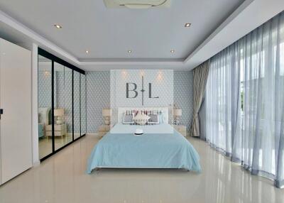 Spacious bedroom with modern decor and large windows