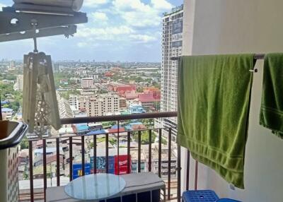 High-rise balcony view with air conditioning units and laundry area