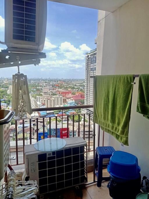 High-rise balcony view with air conditioning units and laundry area