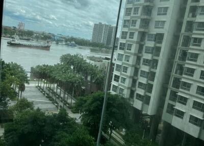 View of the city skyline and river from a high-rise building window