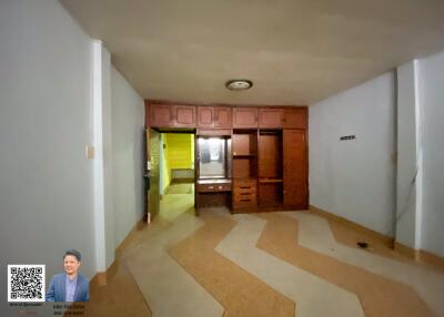 Living room with built-in wooden cabinets.