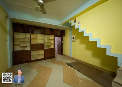 Living room with built-in shelves and stairs