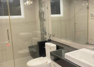 Modern bathroom with glass shower and large mirror