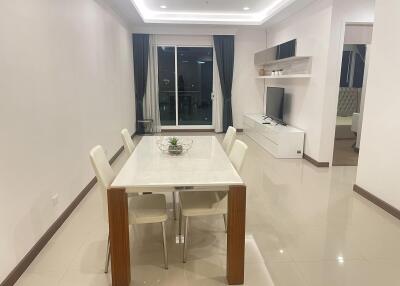 Modern dining room with table set for four, open to living area