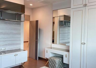 Modern bedroom with built-in cabinets and vanity area