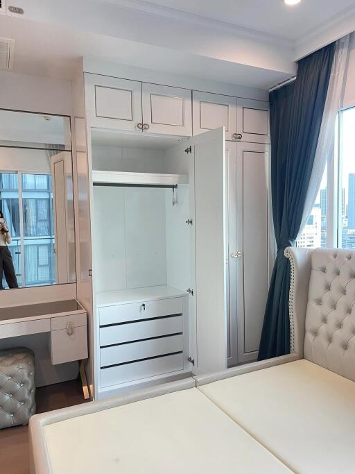 Bedroom with white built-in wardrobe and vanity