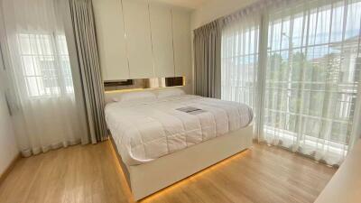 Modern bedroom with large windows and natural light