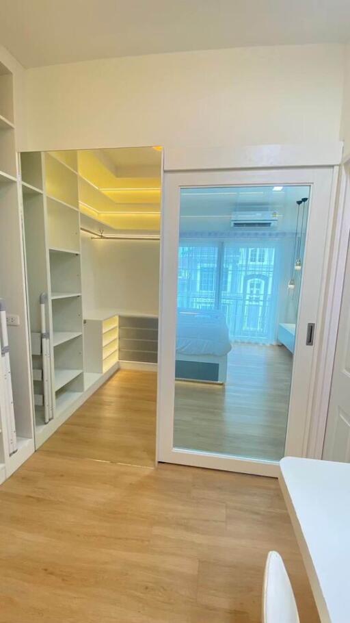 Spacious bedroom with walk-in closet and modern lighting