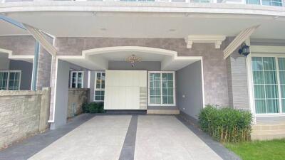 Elegant house facade with driveway and greenery