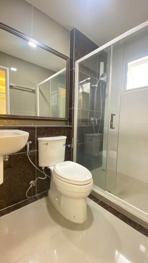 Modern bathroom with glass shower enclosure and wall-mounted sink