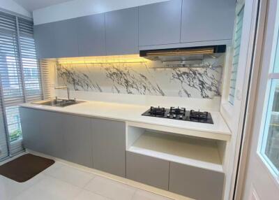 Modern kitchen with minimalist design and marble backsplash