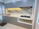 Modern kitchen with minimalist design and marble backsplash