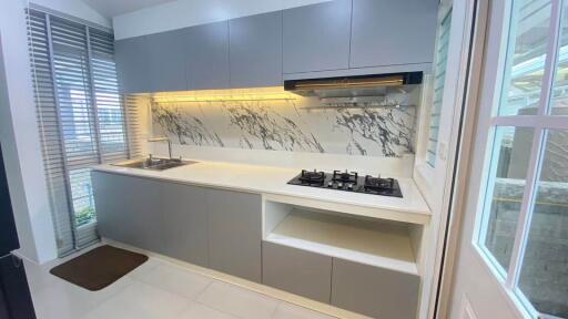 Modern kitchen with minimalist design and marble backsplash