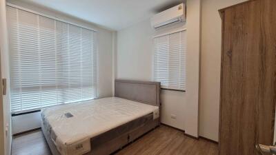 Modern bedroom with large window and air conditioner