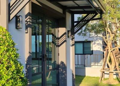 Modern house main entrance with glass door and overhang