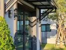 Modern house main entrance with glass door and overhang