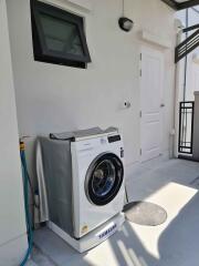 Outdoor laundry area with washing machine