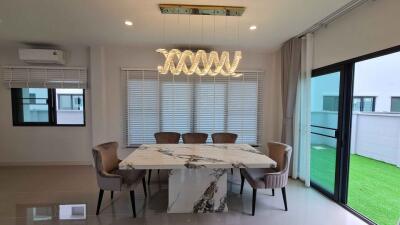 Modern dining room with marble table and stylish lighting