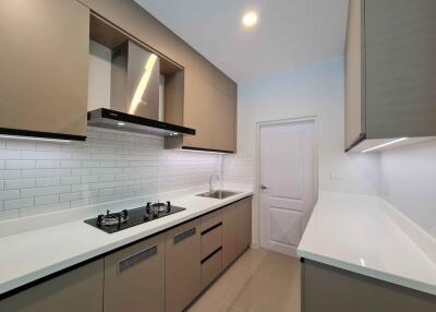 Modern kitchen with fitted appliances and sleek cabinetry