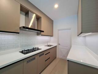 Modern kitchen with fitted appliances and sleek cabinetry