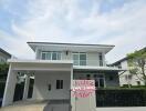 Modern two-story residential building with a carport