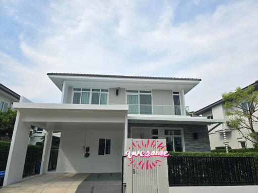 Modern two-story residential building with a carport