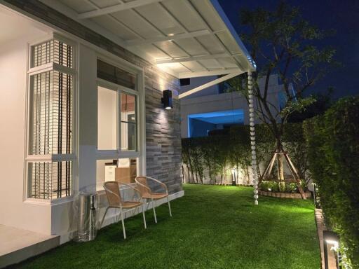 Well-lit backyard with chairs