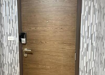 Main door with modern lock and patterned wallpaper