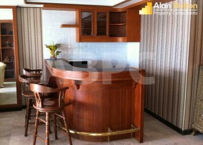 Wooden kitchen with bar stools and countertop