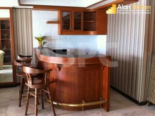 Wooden kitchen with bar stools and countertop