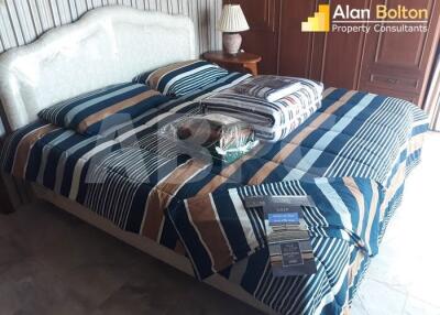 Bedroom with striped bedding and bedside table