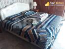 Bedroom with striped bedding and bedside table