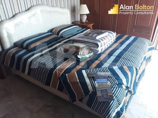 Bedroom with striped bedding and bedside table