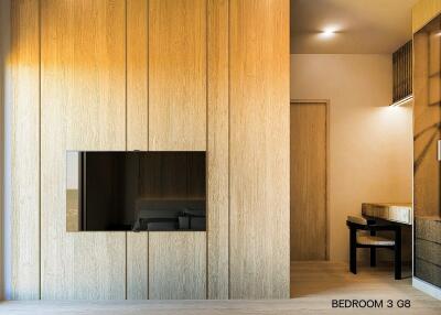 Modern bedroom with wooden cabinetry and desk area