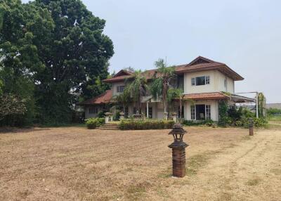 Exterior view of a large house with a yard