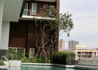 Outdoor swimming pool with view of modern apartment building