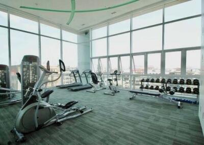 Spacious gym with workout equipment and large windows