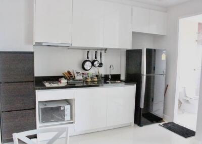 Modern kitchen with white cabinets and black countertop