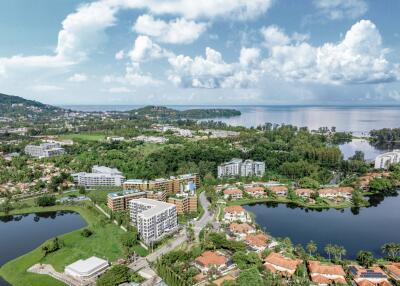 Aerial view of a residential neighborhood with buildings, greenery, and bodies of water