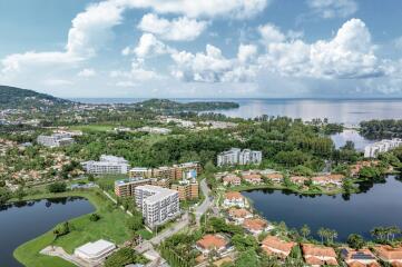 Aerial view of a residential neighborhood with buildings, greenery, and bodies of water