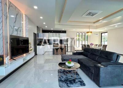 Spacious living room with modern decor and open kitchen