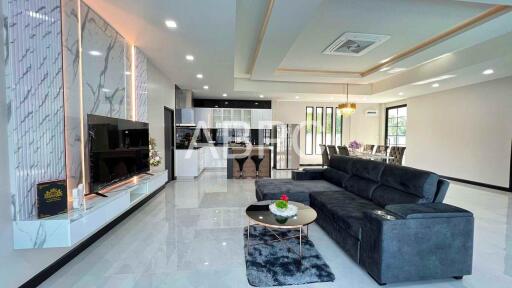 Spacious living room with modern decor and open kitchen