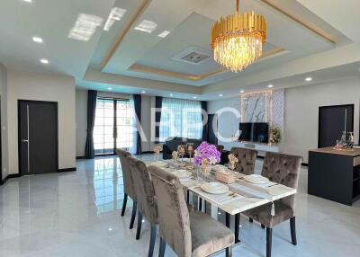 Modern dining room and living area with chandelier