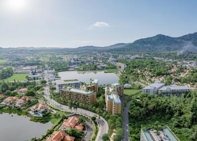 Aerial view of modern residential complex surrounded by greenery and water bodies