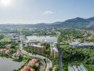 Aerial view of modern residential complex surrounded by greenery and water bodies