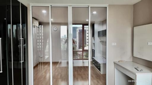 Modern living area with glass sliding doors and wooden flooring